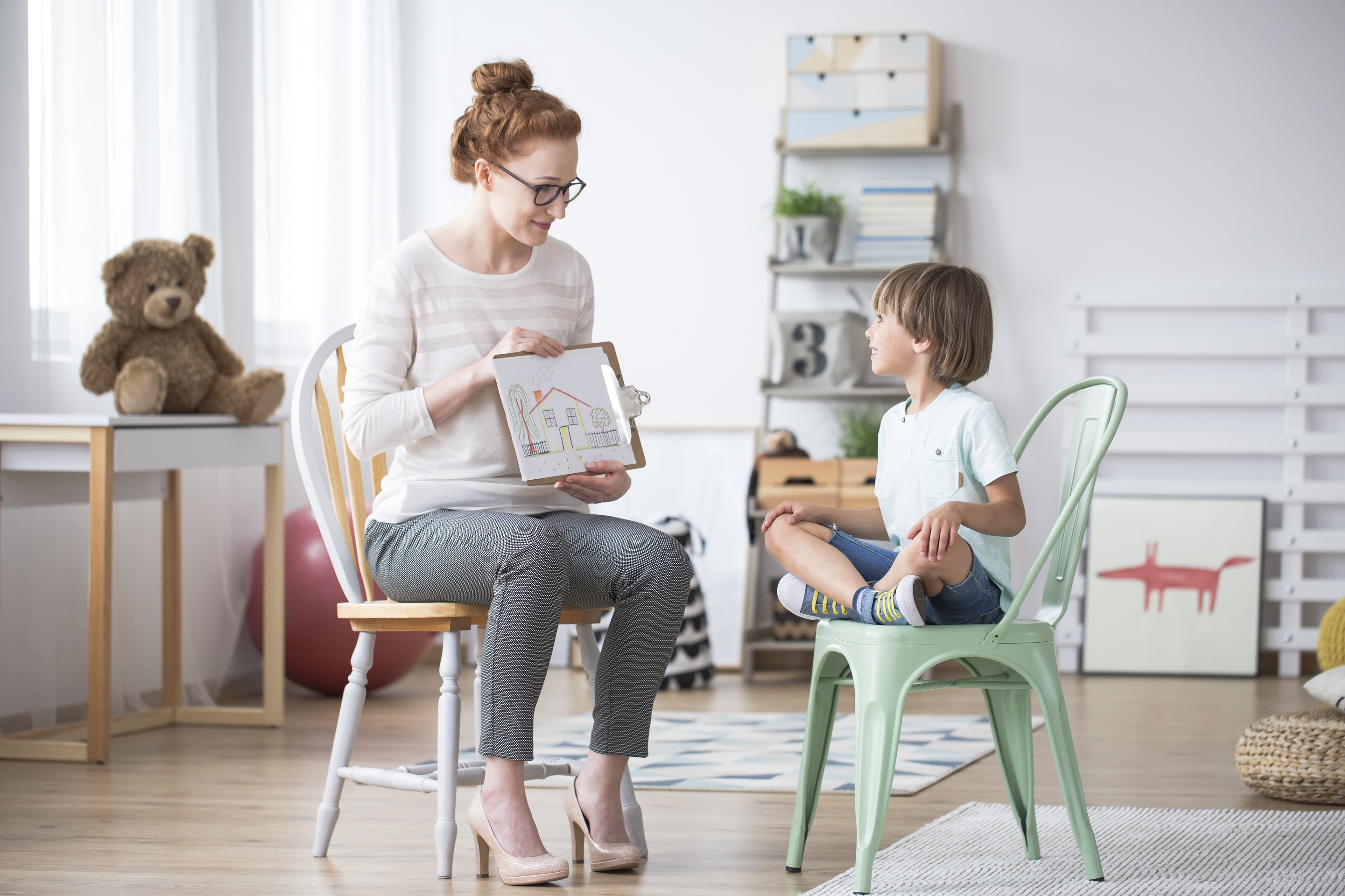 adult helping child with autism